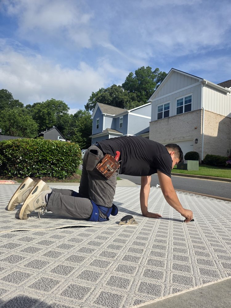 The Royal Flooring Group installer carefully cutting a patterned carpet