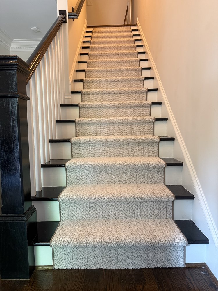 Custom carpet runner installed on a hardwood staircase